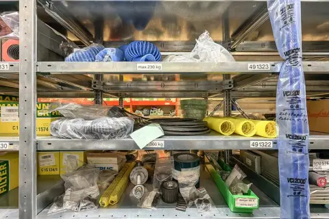 Contents of 3 shelf levels: machine spare parts