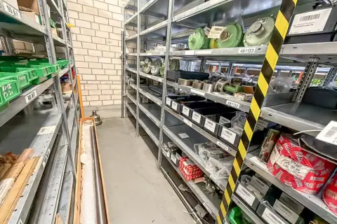 Contents of 3 shelves: machine spare parts