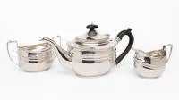 Tea service comprising pot, sugar bowl and milk jug, London, 1913, sterling, ebonised wood handles, total approx. 912 g