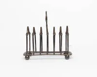 Toast rack, B & Co, silver-plated, on ball feet, rectangular profile, seven bridges with Gothic gable form, central loop handle, approx. 16.5 x 16.5 x 9 cm