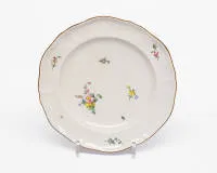 Plate, Höchst, iron-red wheel mark, probably 18th c., shaped form, floral overglaze decor, gold rim, ø approx. 25 cm, gold rim slightly rubbed, one small chip
