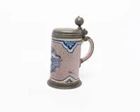 Stoneware tankard, probably Central German, dated 1740, cylindrical body with handle, white glazed, manganese-violet ground and blue painted decoration, domed lid and flared foot mounted in pewter, lid dated 1740 and with...