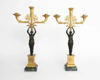 Pair of figurative girandoles, Empire, France, 1st half 19th c., partly gilt, three-light candelabra each with rich Empire decoration supported by a caryatid on marble base, H. 49 cm