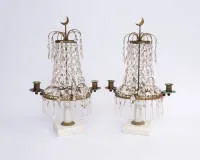 A pair of table candlesticks / candle holders, Louis XVI, Sweden, 19th century, each two-light with rich glass pendants under crowning crescent moon, marble base, H. 40 cm