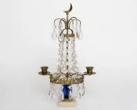 Classicist candlestick, Sweden, 19th c., gilded bronze, two-flame candlestick with glass pendants on marble base, cobalt blue glass element, crescent moon finial, H. 39 cm