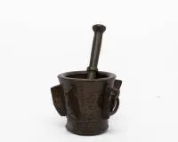 Winged mortar, probably Iberian, 16th c. or later, cast bronze, conical form with six vertical ribs on the sides as handles, one rib pierced with ring, H. 13 cm, with a pestle, signs of age, base ring with solder joint.