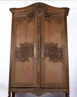 Norman marriage cupboard, France, around 1800, oak, panelled body with two doors under curved and multi-profiled cornice with carved frieze, doors with curved panels and rich floral...