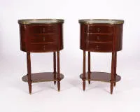 A pair of guéridons / side tables, Louis XVI, France, mahogany, each oval body with three drawers and white marble top, openwork bronze gallery, pilasters and legs with fluting, kidney-shaped panels, 77 x 49 x 37.5 cm