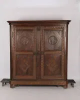 Classicist wedding cabinet, dated 1823, oak, two-door body in panelled construction with chamfered pilasters, the latter with carved fluting, rich relief carvings with meander bands on all sides as well as floral and geometric...