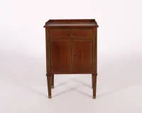 Guéridon / side cabinet, Louis XVI style, France, probably 19th c., mahogany, straight body with fluted pilasters and matching feet, top drawer above two-door compartment, one key, 70 x 48.5 x 33 cm