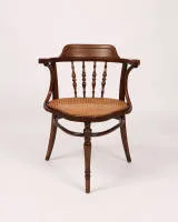 Schreibfauteuil, Jacob & Josef Kohn, Wien, um 1900, Eichenbugholz, Sitz mit Wiener Geflecht, Korpus mit Armlehnen, in der Rückenlehne mit Balusterstreben, unterseitig mit originalem Herstelleretikett und Schablonierung, H. 82 cm, Sitz mit geringer...