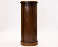 Corner cabinet in Biedermeier style, German or Austrian, around 1900, walnut and walnut veneer, ornamental painted decoration, tall semicircular body with single-door curved front, profiled cornice and base, door and upper frieze with stylized...