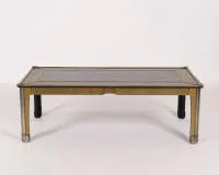 Mid Century coffee table, probably Italy, 1970s, etched brass and mirror glass, rectangular piece with full-surface brass cladding, partly ornamentally etched, in the top a mirror element, feet with volutes in Art...