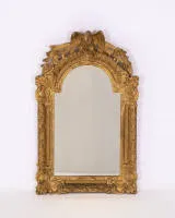 Representative wall mirror, Régence, France, 18th c., richly decorated frame with round crest under a crowning eagle and openwork foliage, 84 x 52 cm, signs of age and additions