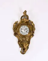 Cartel clock, Louis XV, France, circa 1765, signed "BUNON A PARIS", partly gilded brass case with crowning rooster and corresponding fox on base, framed by acanthus scrolls and oak leaves, movement also signed...