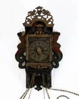 Frisian chair clock, Netherlands, 18th/19th c., polychrome painted wooden case with openwork, partially gilded metal appliqués and flanking mermaids, painted dial with Roman hours and Arabic minutes, central...