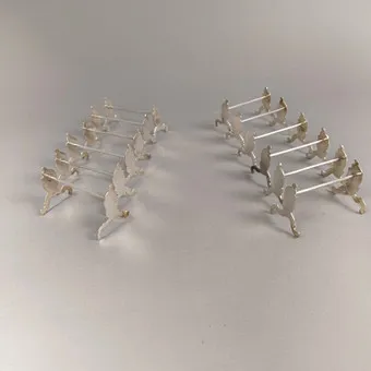 SATZ VON 12 MESSERBÄNKCHEN SILBER.