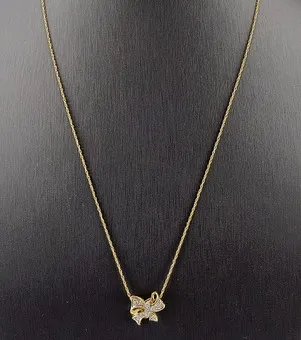 10K BOW PENDANT WITH DIAMONDS ON CHAIN.