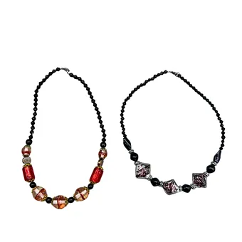 Two necklaces with faceted elements and patterned glass beads.