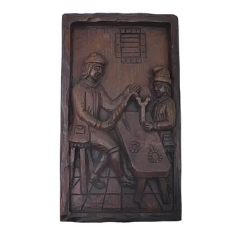 HOLZRELIEF EINES MÜNZMEISTER MIT LEHRLING.