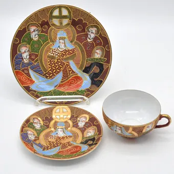 THREE-PART SATSUME TEA SERVICE: CUP, SAUCER AND PLATE, FROM JAPAN, EARLY 20TH CENTURY.