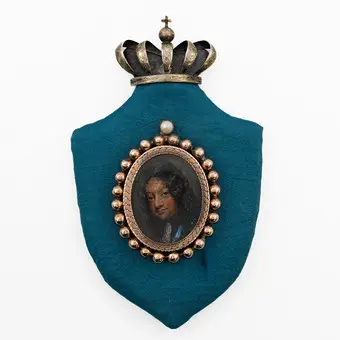 ANDREAS THORNBORG (1730-1780). KRÓL CHRYSTIAN V DUŃSKI. MINIATURA (TEMPERA NA PŁYCIE), POZŁACANA OPRAWA MEDALIONOWA, MONTOWANA NA PŁYCIE W KSZTAŁCIE TARCZY, KORONA Z POZŁACANEGO SREBRA, XVII-XVIII W.