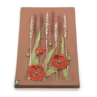 AIMO NIETOSVUORI JIE GANTOFTA. CERAMIC DESIGNER WALL PLAQUE; WHEAT WITH POPPY MOTIF.