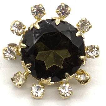 FRANZÖSISCHE STRASS BROSCHE MIT RAUCHGLASFARBIGEN UND WEISSEN FARBSTEINEN UM CA. 1940.