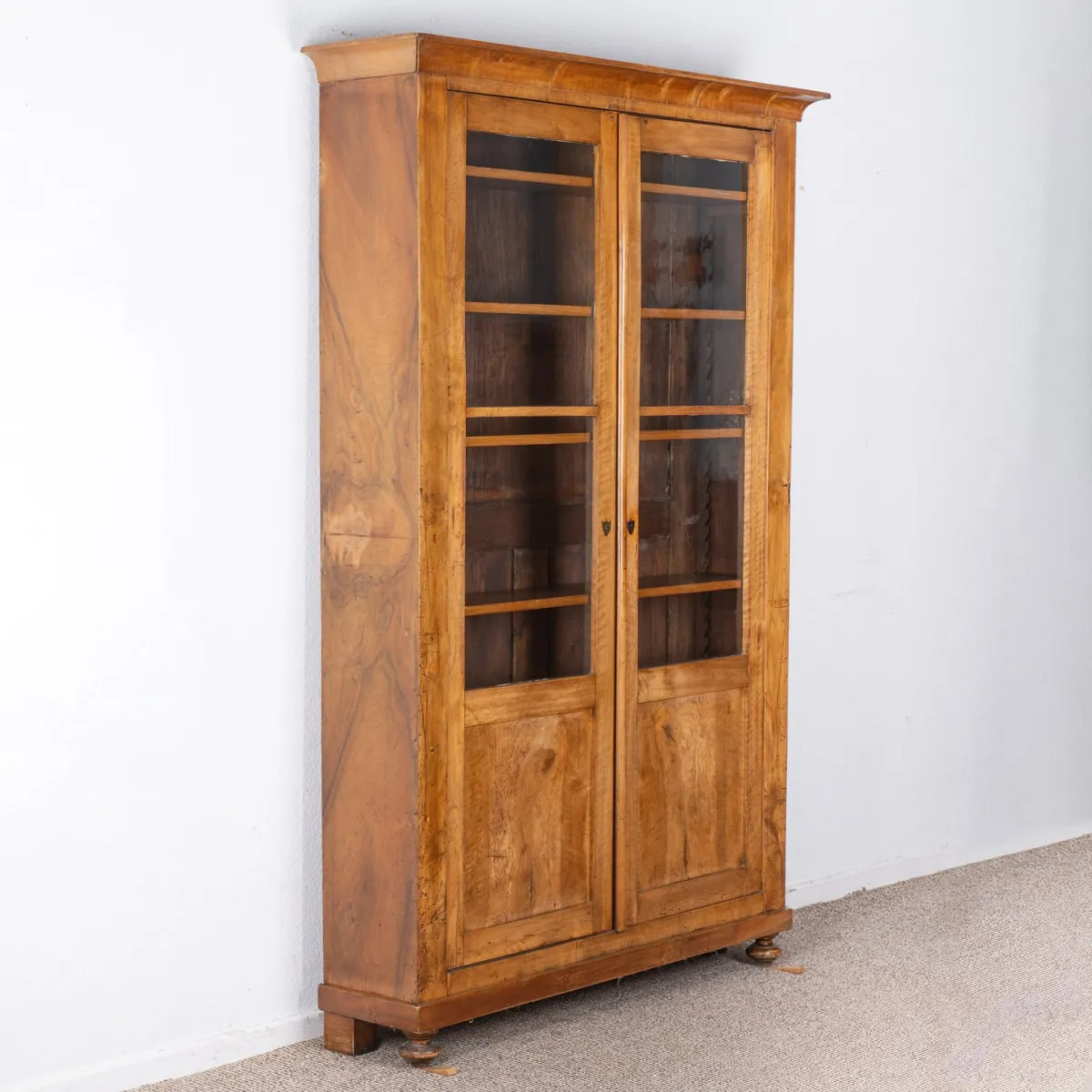 Classic bookcase, Baden, 19th century, solid walnut and veneered on softwood carcass, two doors, with ratchet