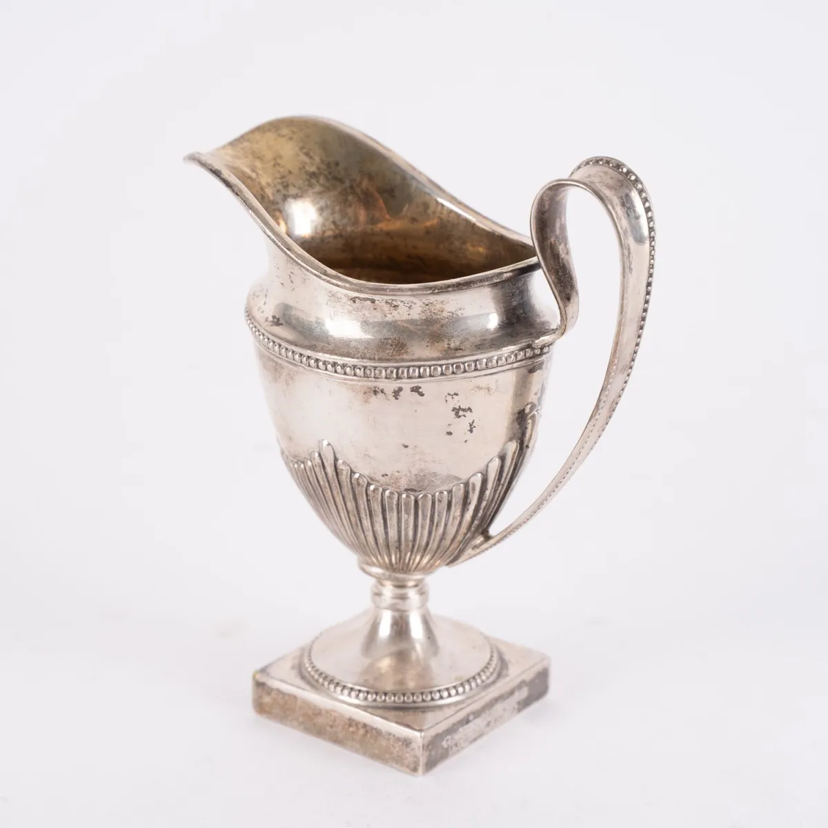 Heavy cream jug in classicist design, solid 800 silver, approx. 175g, height approx. 12 cm. Base below...