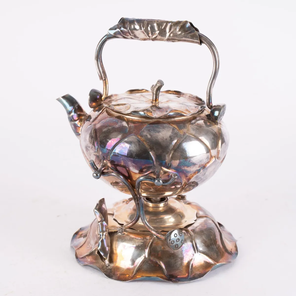 Teapot on rechaud, vegetal decor, silver-plated metal. Total height including handle approx. 23.5 cm, length of pot approx.…