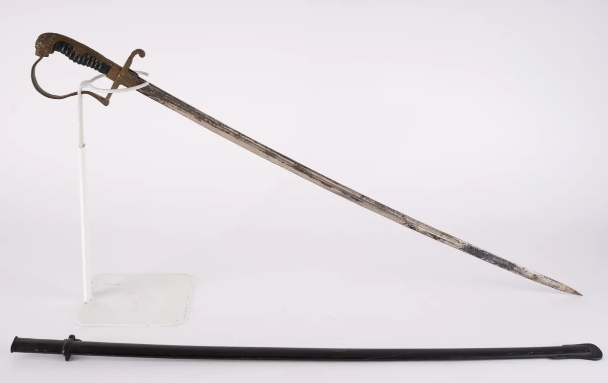 Lion head saber for army officers with red glass eyes.