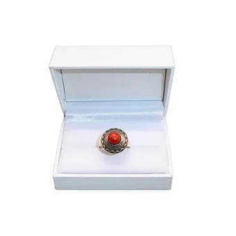 Silver ring with round coral cabochon in domed setting