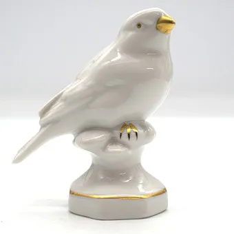 Gerold porseleinen vogel, wit en goud.