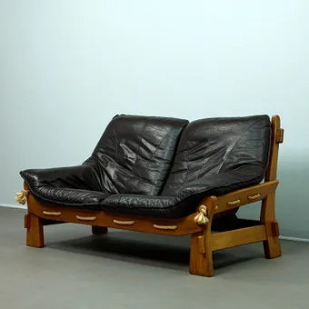 MAISON REGAIN. Attributed, brutalist sofa / two-seater, oak, leather, 1970s, France.