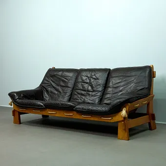 MAISON REGAIN. Attributed, brutalist sofa / three-seater, oak, leather, 1970s, France.