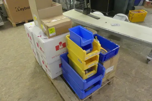 Bundle of storage bins and boxes with contents (electronic components, cables, small parts)