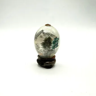 Filigree glass decorative egg painted from the inside - mountain landscape - wooden stand.