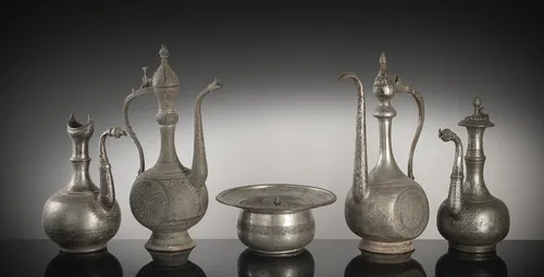 Group of four pitchers and a warming dish made of tinned copper