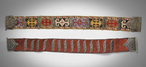 Two fine belts with silver appliqués, partly gilded, belts in lackey embroidery or leather