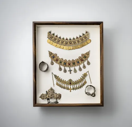 Group of jewellery, incl. chains, bangles and earrings, partly silver, mounted in two glass cases