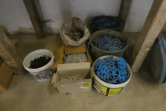 Mixed lot of reinforcement spacers and insulation dowels in buckets, boxes and sack