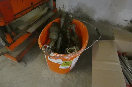 Bucket with assorted water fittings, valves, Storz couplings and drain cocks