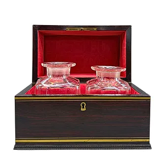 Wooden spirits case with two glass decanters - dated 1854.