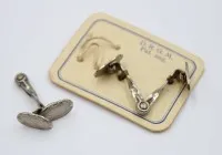 Paar Manschettenknöpfe, um 1920, silberfarben.