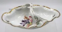 2x kl. Schälchen, , älter, beide Oskar Schlegelmilch, florales Dekor, bei Henkelschale Gold etwas berieben, H-6,5cm, B-17,5cm und 16x9 cm