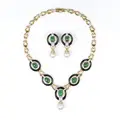 Opulent Lavallière gold necklace and ear clips with emerald cabochons, onyx and diamonds.