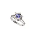 White gold flower entourage ring with tanzanite solitaire and brilliants.
