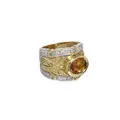 Band ring with floral motif and central Madeira citrine.