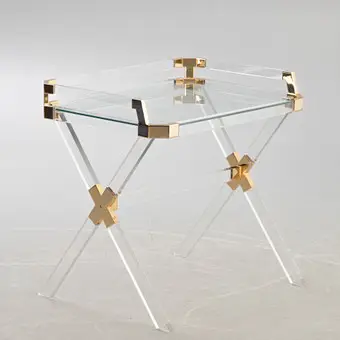 Acrylic table with gold metal fittings.